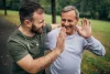 Two adult men encouraging each other during outdoor physical activity