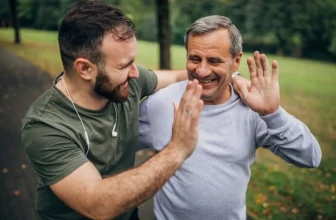 Two adult men encouraging each other during outdoor physical activity
