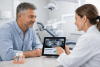 Patient discussing dental implant treatment with a dentist