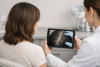 Woman discussing scalp and donor-hair assessment with a clinician