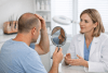 Patient discussing scalp healing after a hair transplant with a clinician
