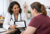 Bariatric specialist discussing weight-loss progress with a patient